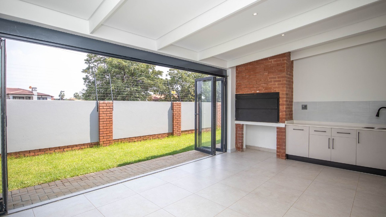 Covered braai area opening onto the garden